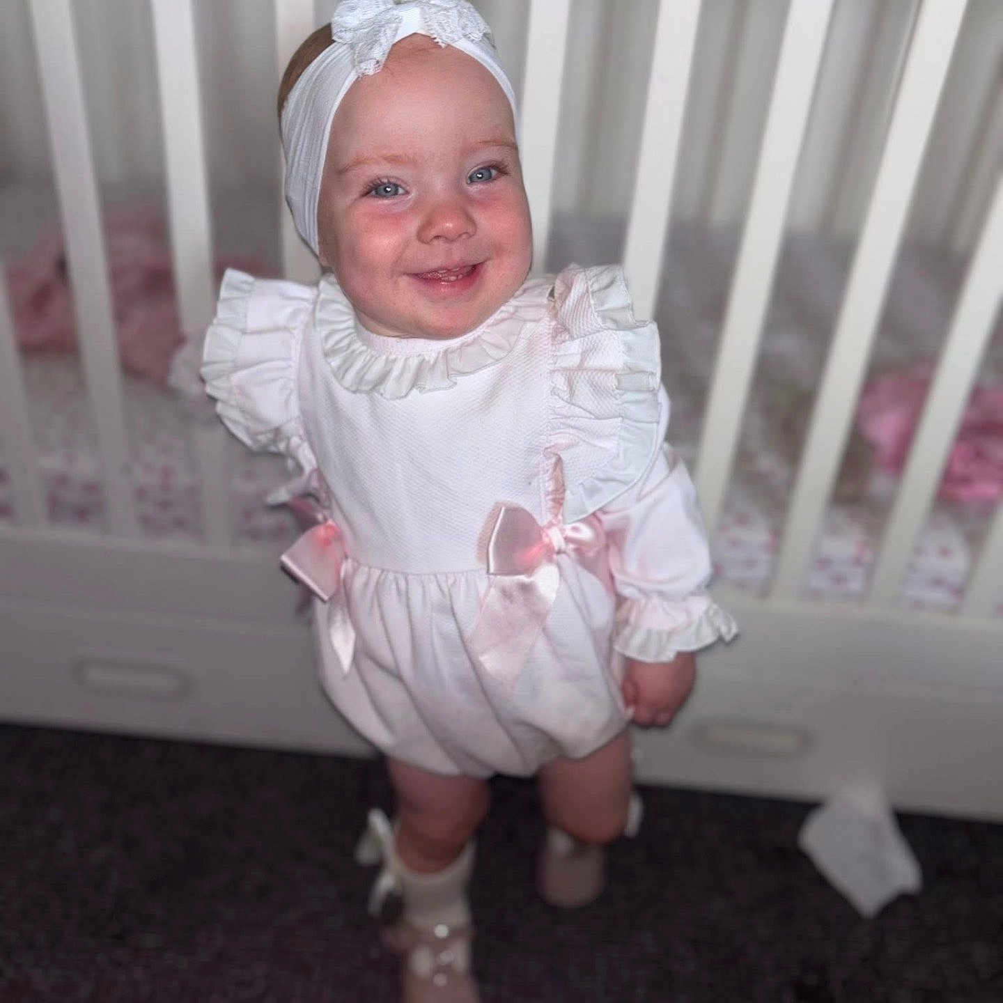 Paula-Cia joined the competition — help win amazing prizes! baby, bow, child, crib, cute, floor, footwear, furniture, happy, headband, indoors, infant, person, portrait, ribbon, smile, sock, standing, white_dress, young_child