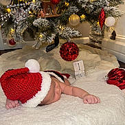 Elier joined the competition — help win amazing prizes! baby, blanket, celebration, christmas_ornaments, christmas_tree, cozy, cute, decorations, festive, holiday, indoor, infant, lights, milestone, newborn, peaceful, red_hat, santa_hat, sleeping, soft_texture