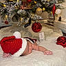 baby, blanket, celebration, christmas_ornaments, christmas_tree, cozy, cute, decorations, festive, holiday, indoor, infant, lights, milestone, newborn, peaceful, red_hat, santa_hat, sleeping, soft_texture