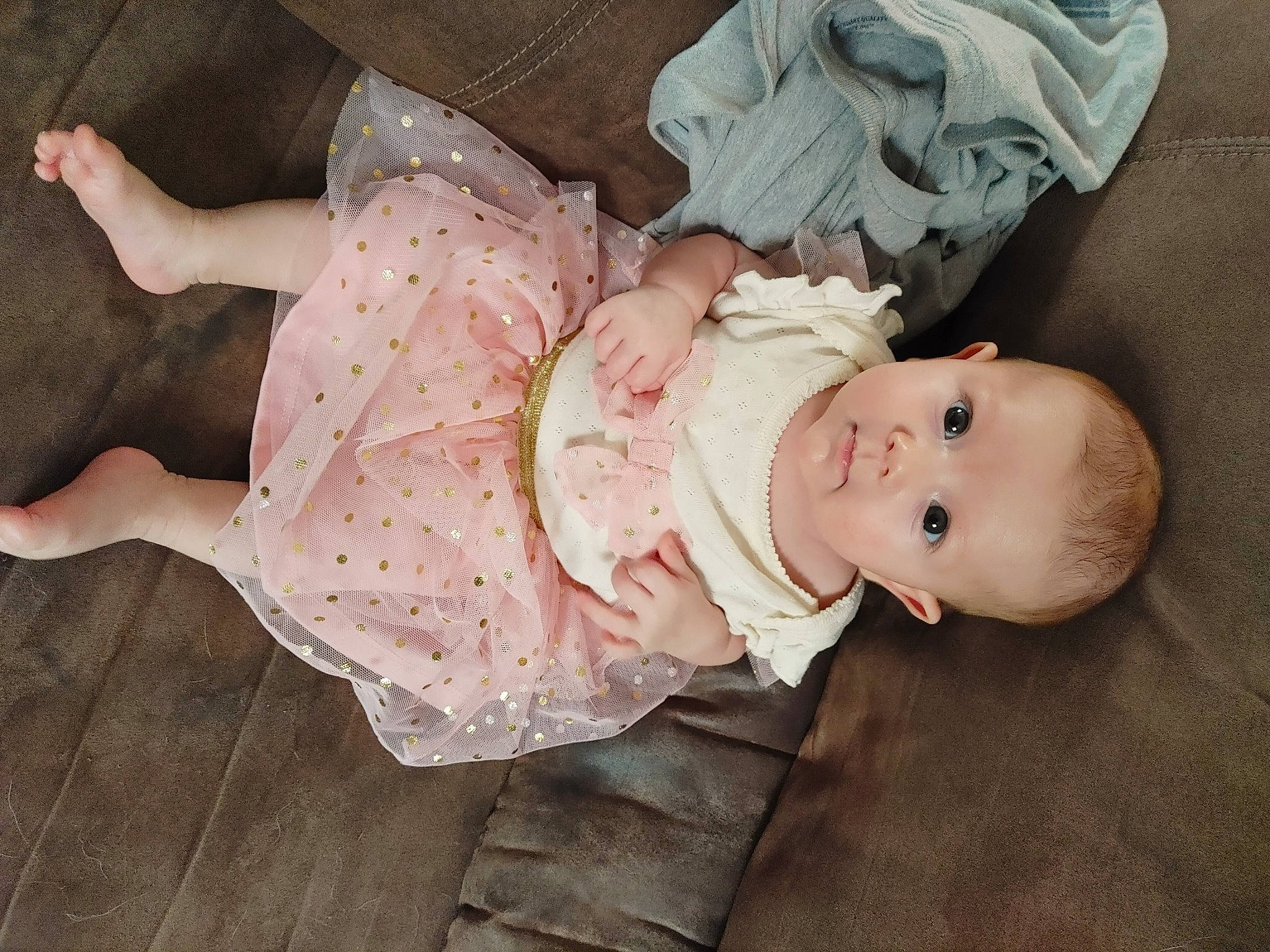 Vivien is registered to the contest to win money with this photo: baby, baby_products, baby_toddler_clothing, cheek, child, comfort, dress, eye, face, flash_photography, grass, hand, human_body, iris, pattern, person, pink, skin, sleeve, toddler