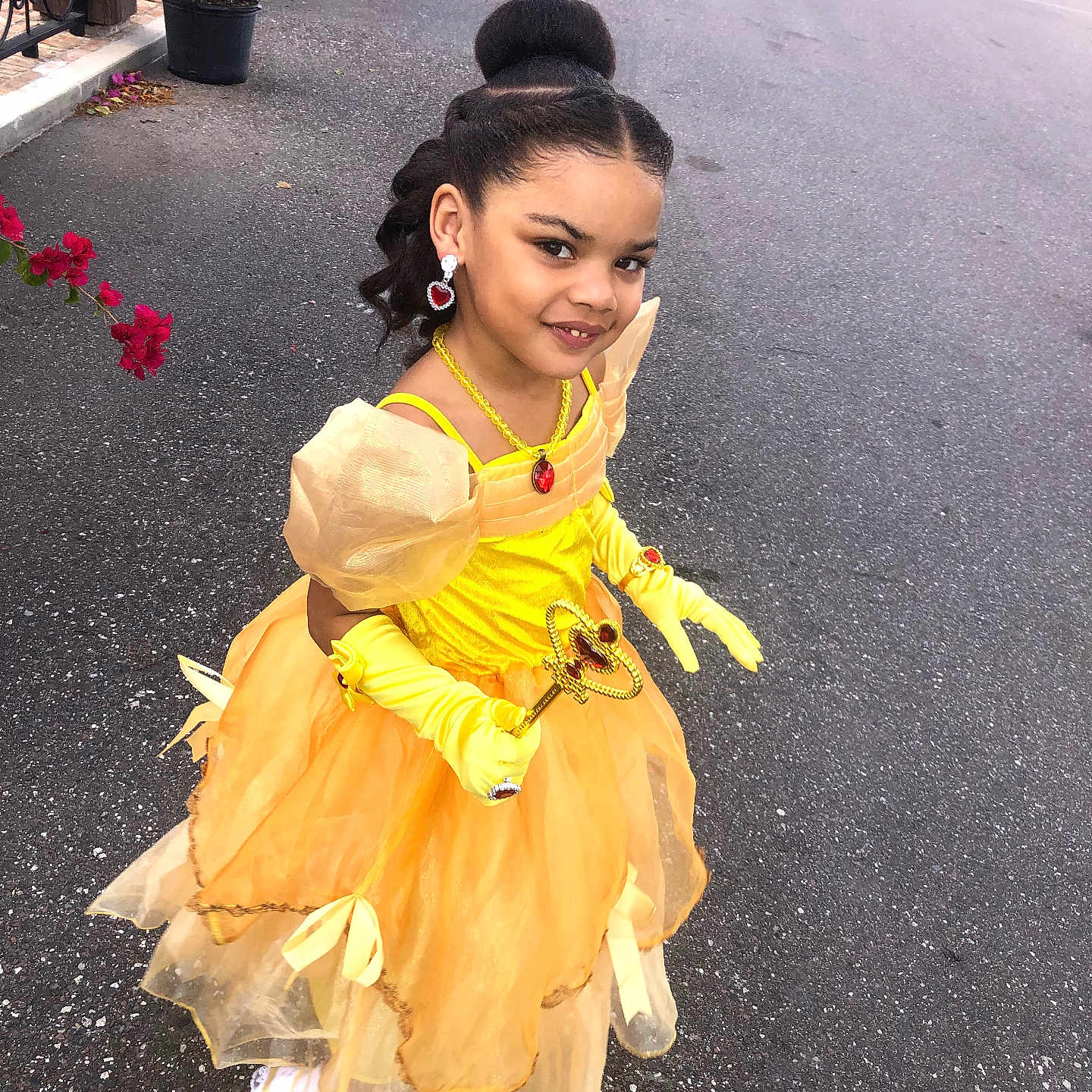 Jbriya is registered to the contest to win money with this photo: child, costume, curly_hair, daytime, dress, earrings, girl, gloves, hair_bun, happy, necklace, outdoor, posing, princess, scepter, shoes, sidewalk, smile, street, yellow_dress