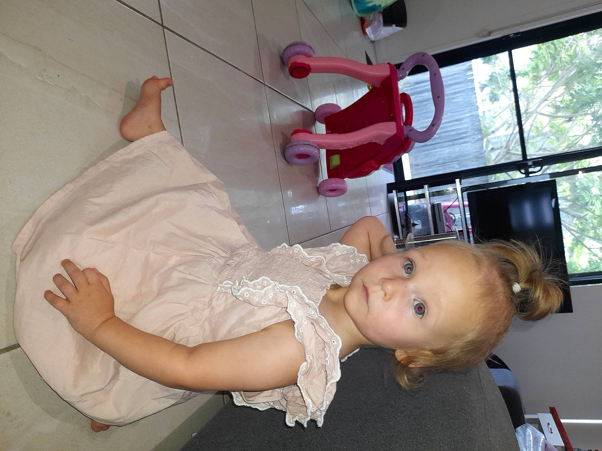 Helena is registered to the contest to win money with this photo: abdomen, baby, baby_products, baby_toddler_clothing, child, comfort, dress, elbow, fun, happy, human_leg, joint, magenta, person, room, shoulder, smile, toddler, white, window