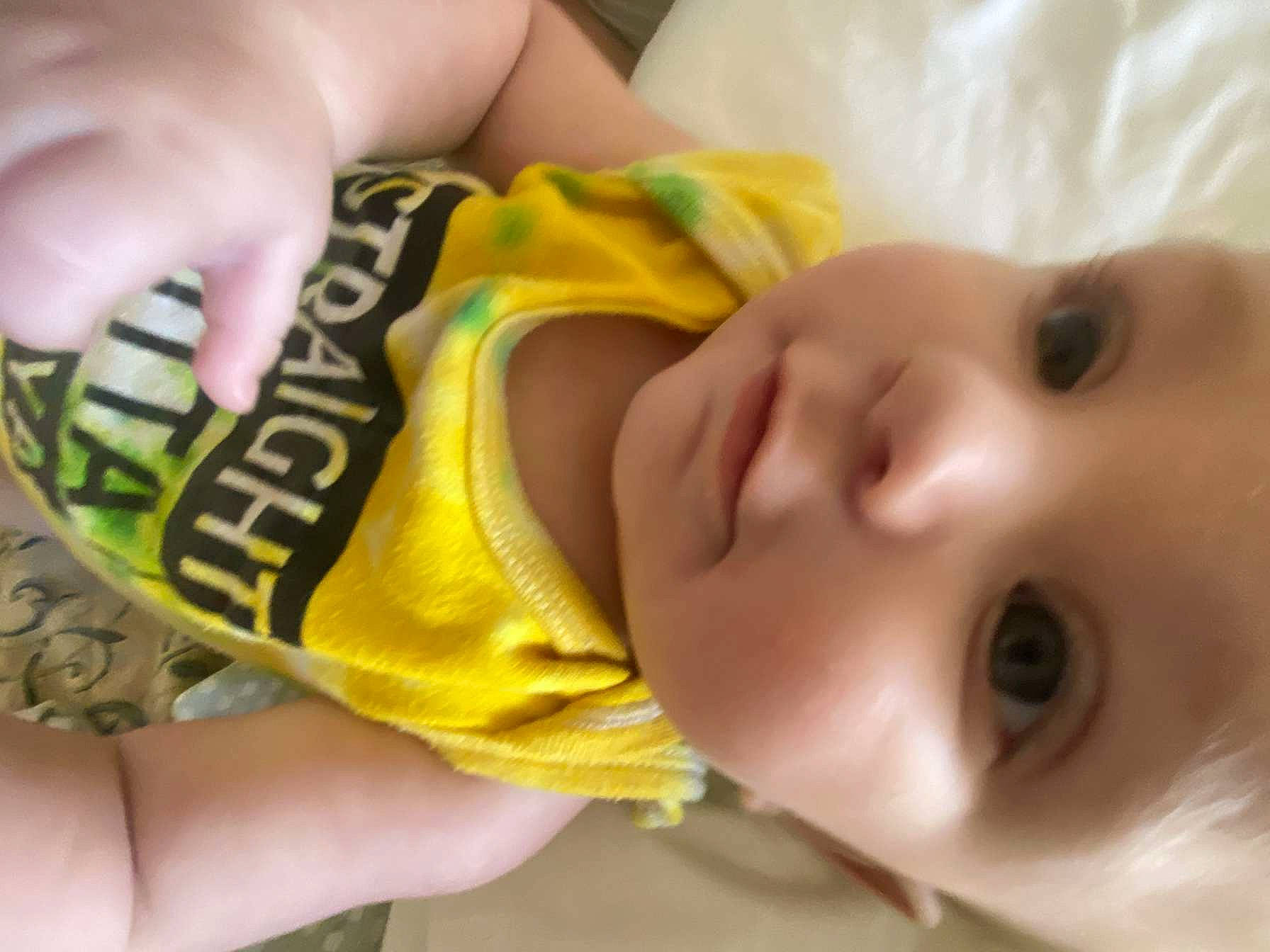 Harlee is registered to the contest to win money with this photo: baby, baby_products, baby_toddler_clothing, cheek, child, close_up, ear, eyebrow, eyelash, facial_expression, finger, happy, mouth, neck, nose, person, skin, sleeve, thumb, toddler