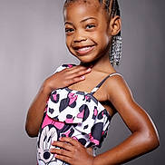 Amiyah is registered to the contest to win money with this photo: accessories, background, black_pants, bow, braids, child, confident, cute, earrings, fashion, fashionable, girl, happy, minnie_mouse, portrait, posing, smile, studio, tank_top, young