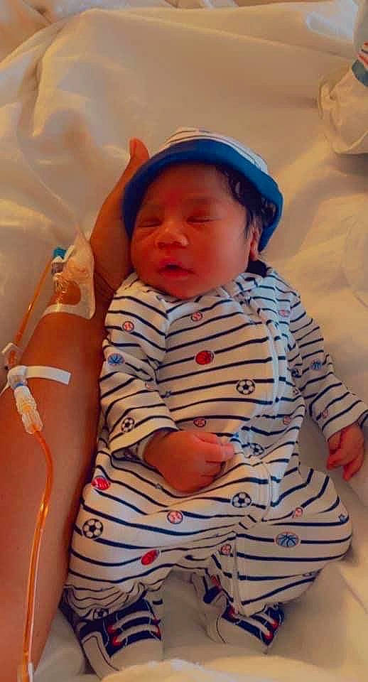 Quadir Sullivan joined the competition — help win amazing prizes! abdomen, baby, baby_toddler_clothing, cap, cheek, child, comfort, facial_expression, finger, hat, headwear, human_leg, pattern, person, sitting, skin, sleeve, stomach, tableware, thigh