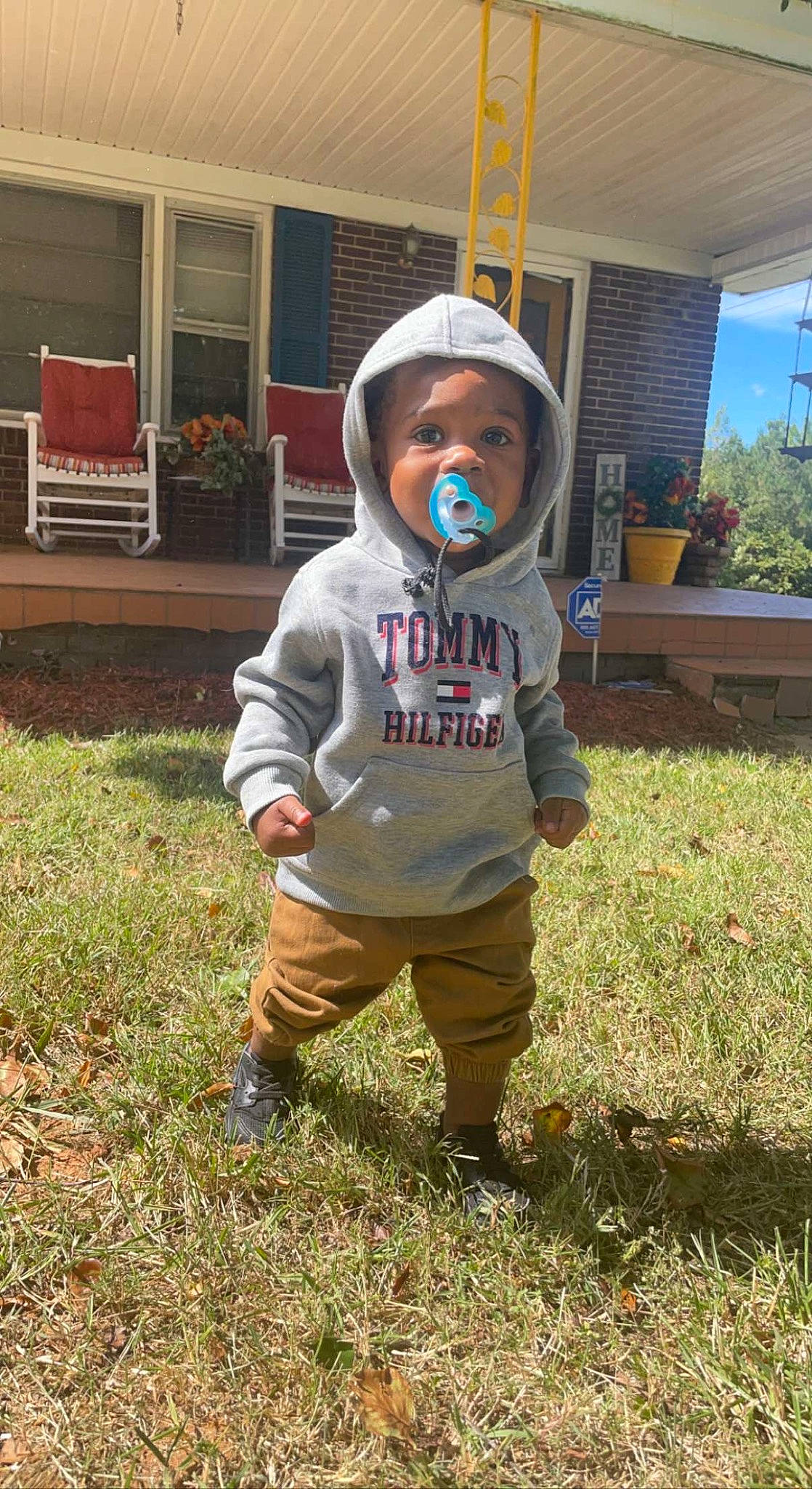 Quadir Sullivan is registered to the contest to win money with this photo: baby, child, costume, fun, garden, grass, hat, headwear, helmet, house, landscape, lawn, lawn_ornament, leaf, person, personal_protective_equipment, plant, play, soil, toddler