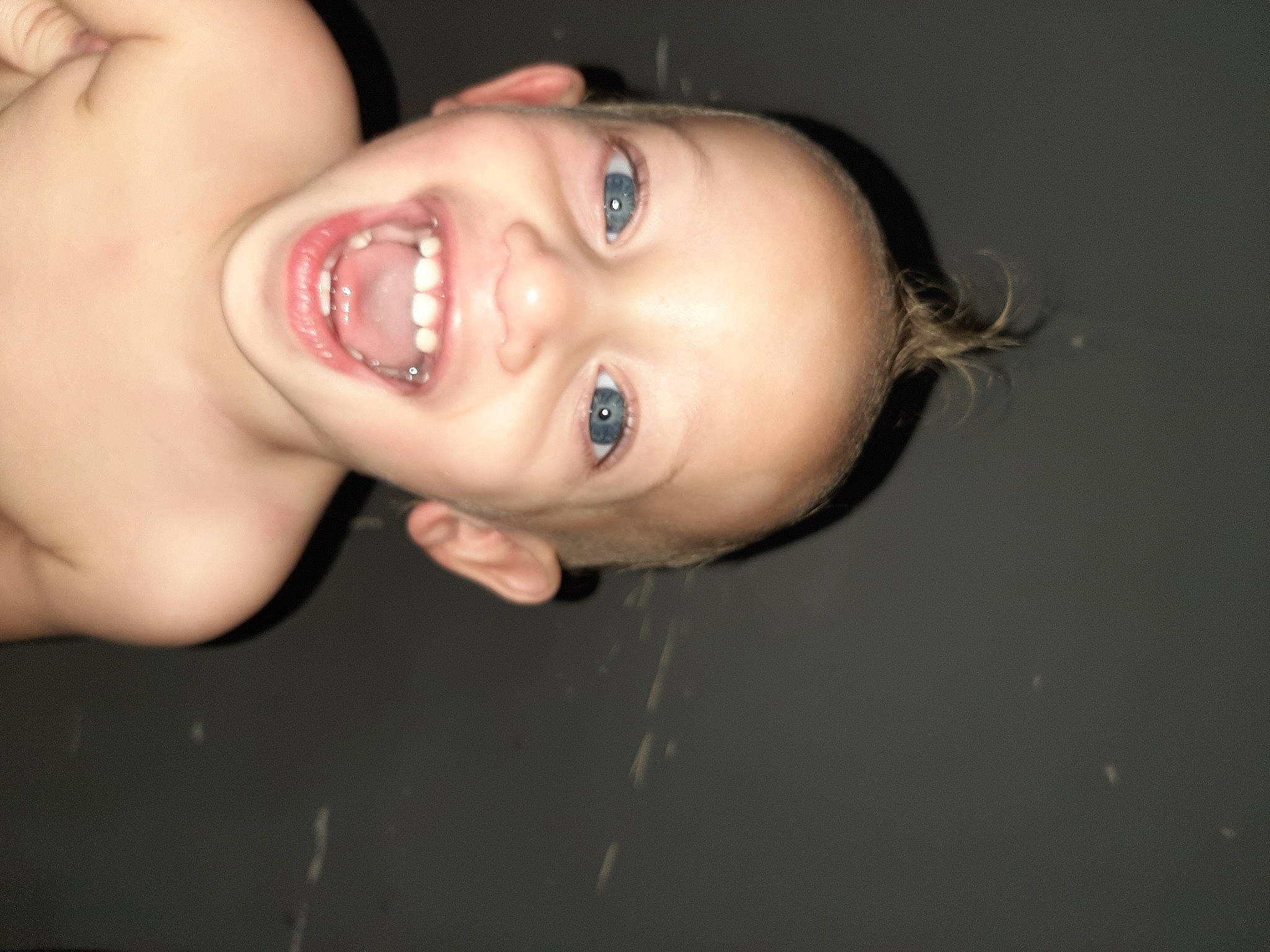 Kahlil is registered to the contest to win money with this photo: arm, bathing, black_hair, cheek, chest, ear, eyelash, flash_photography, gesture, hand, happy, human_body, iris, jaw, lip, neck, nose, person, smile, toddler