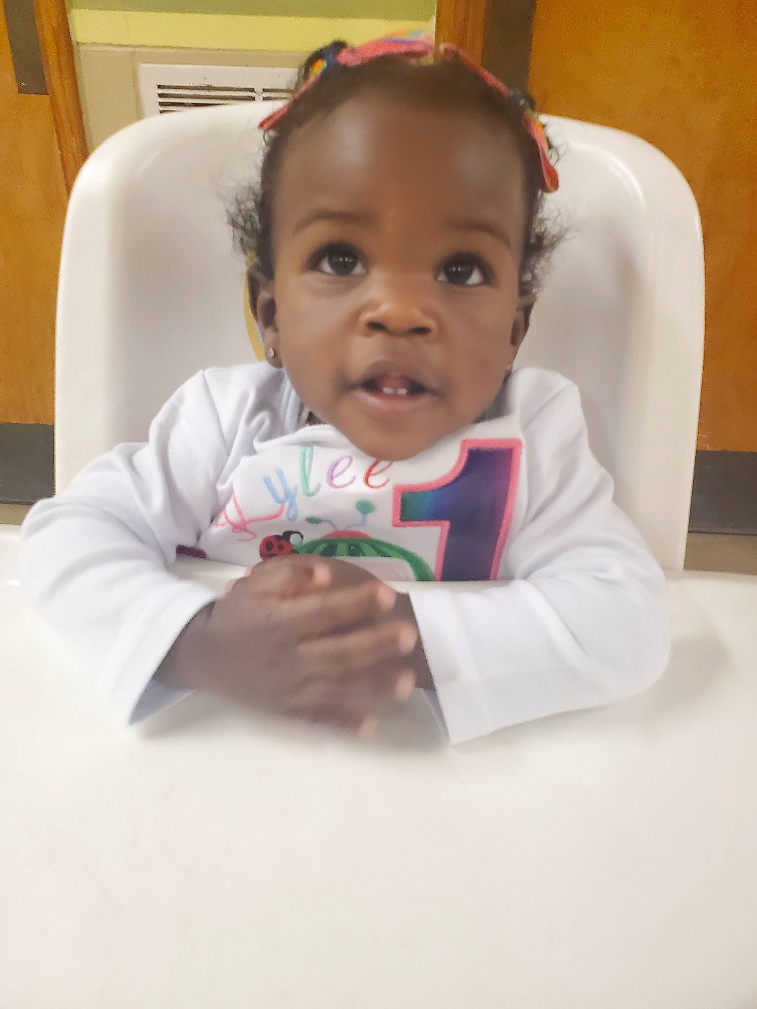 Kylee is registered to the contest to win money with this photo: audio_equipment, baby, cheek, child, comfort, ear, elbow, eyelash, finger, flooring, fun, gadget, happy, iris, person, reading, room, sitting, smile, toddler