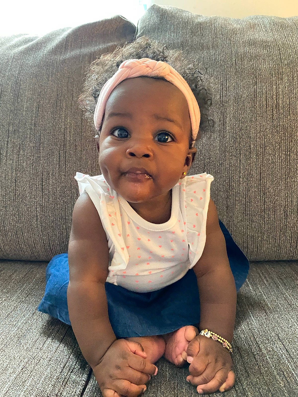 Kylee is registered to the contest to win money with this photo: baby, baby_toddler_clothing, cheek, chin, comfort, couch, dress, eye, eyebrow, flash_photography, happy, head, iris, lip, nose, person, sleeve, smile, textile, toddler