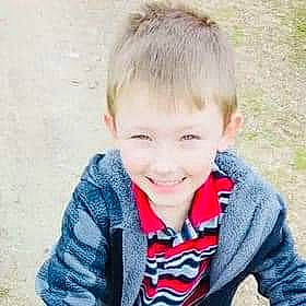 Joshua joined the competition — help win amazing prizes! blond, cheek, child, electric_blue, eye, eyebrow, fun, grass, happy, human_body, jacket, jaw, joy, laugh, leisure, nose, person, portrait_photography, sitting, sleeve