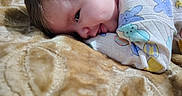 Bellamy joined the competition — help win amazing prizes! baby, blanket, child, closeup, clothing, colorful, cute, face, head, indoor, infant, lying_down, onesie, patterned_blanket, portrait, skin, sleepwear, smile, soft_texture, young_child