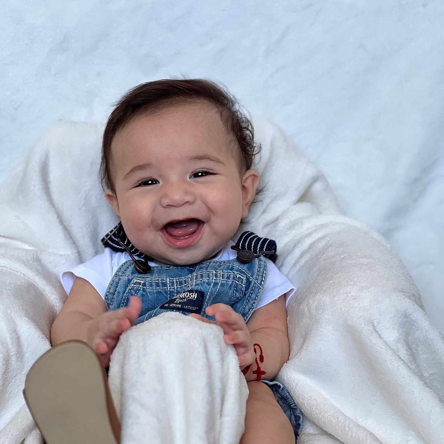 Santee is registered to the contest to win money with this photo: baby, babylaughing, blanket, bodypart, clothing, face, finger, footwear, hand, happy, head, laughing, pants, person, photography, pingpong, pingpongpaddle, portrait, shoe, smile