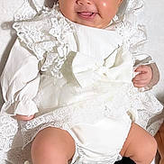 Layan participe au concours pour gagner de l'argent avec cette photo : baby, infant, smiling, headband, bow, white_dress, lace, black_socks, stockings, chubby_legs, portrait, lying_down, hands, feet, cute, adorable, studio_style, soft_background, closeup, skin