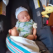Remington joined the competition — help win amazing prizes! baby, bed, car, car_interior, clothing, couch, crib, cushion, face, furniture, hat, head, homedecor, infantbed, newborn, person, photography, portrait, transportation, vehicle