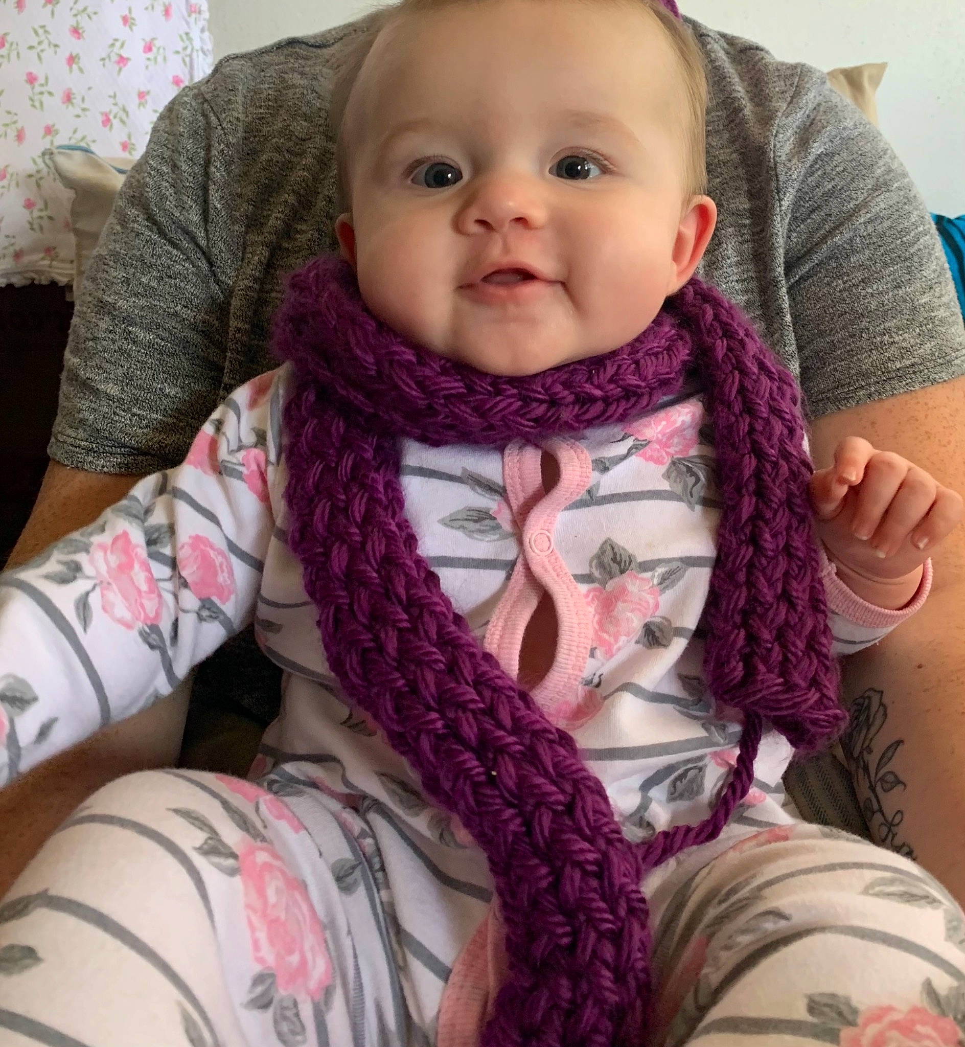 Emberlee is registered to the contest to win money with this photo: arm, baby, cheek, child, crochet, face, hair, head, knitting, lip, long_hair, neck, nose, outerwear, person, pink, scarf, skin, textile, toddler