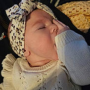 Ellianna joined the competition — help win amazing prizes! baby, sleeping, headband, knitwear, sweater, hand, face, child, infant, cozy, cute, portrait, closeup, indoor, soft_lighting, peaceful, resting, young_child, fashion_accessory, warm_clothing