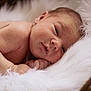 baby, newborn, infant, skin, face, head, arm, hand, fur, blanket, resting, sleepy, cozy, soft, closeup, portrait, cute, peaceful, lying_down, natural_light