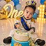 baby, cake, birthday, prince, crown, blue, gold, balloons, celebration, sash, smash_cake, party, marquee_lights, one_year_old, child, festive, floor, happy, portrait, photography