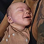 Onofre joined the competition — help win amazing prizes! baby, smiling, sleeping, infant, close_up, tattoo, adult, skin, arm, clothing, brown_shirt, happy, peaceful, cuddling, person, portrait, indoor, cute, joy, love