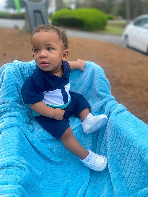 August is registered to the contest to win money with this photo: azure, baby_toddler_clothing, blue, car, electric_blue, eye, fun, grass, happy, human_body, leaf, leisure, mammal, people, person, plant, public_space, recreation, snapshot, summer