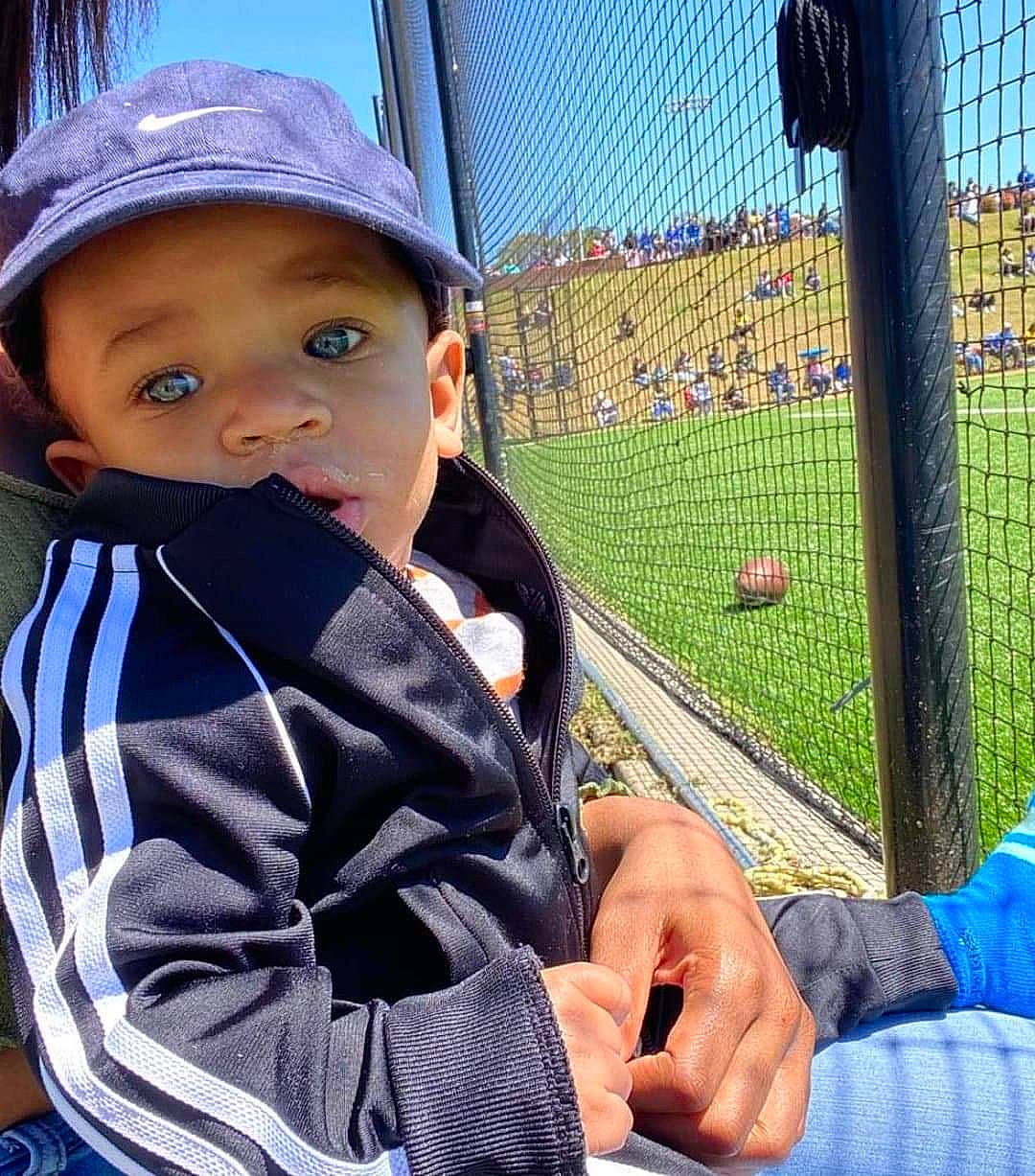 August joined the competition — help win amazing prizes! ball, blue, clothing, cool, eye, fun, grass, hand, hat, head, headwear, human_body, leisure, mesh, person, photograph, product, public_space, sky, sports_equipment