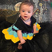 Odessa joined the competition — help win amazing prizes! baby, background_art, black_fabric, child, colorful_clothing, costume, crocheted_dress, cute, face, fantasy, ghost_figure, indoor, planets, portrait, seated, smiling, space_theme, stars, whimsical, young_child
