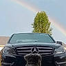 Charles is registered to the contest to win money with this photo: animal, automobile, back_view, car, curly_hair, daylight, dog, driveway, front_view, luxury_car, mercedes, outdoor, pet, photography, rainbow, residential, sitting, sky, tree, vehicle