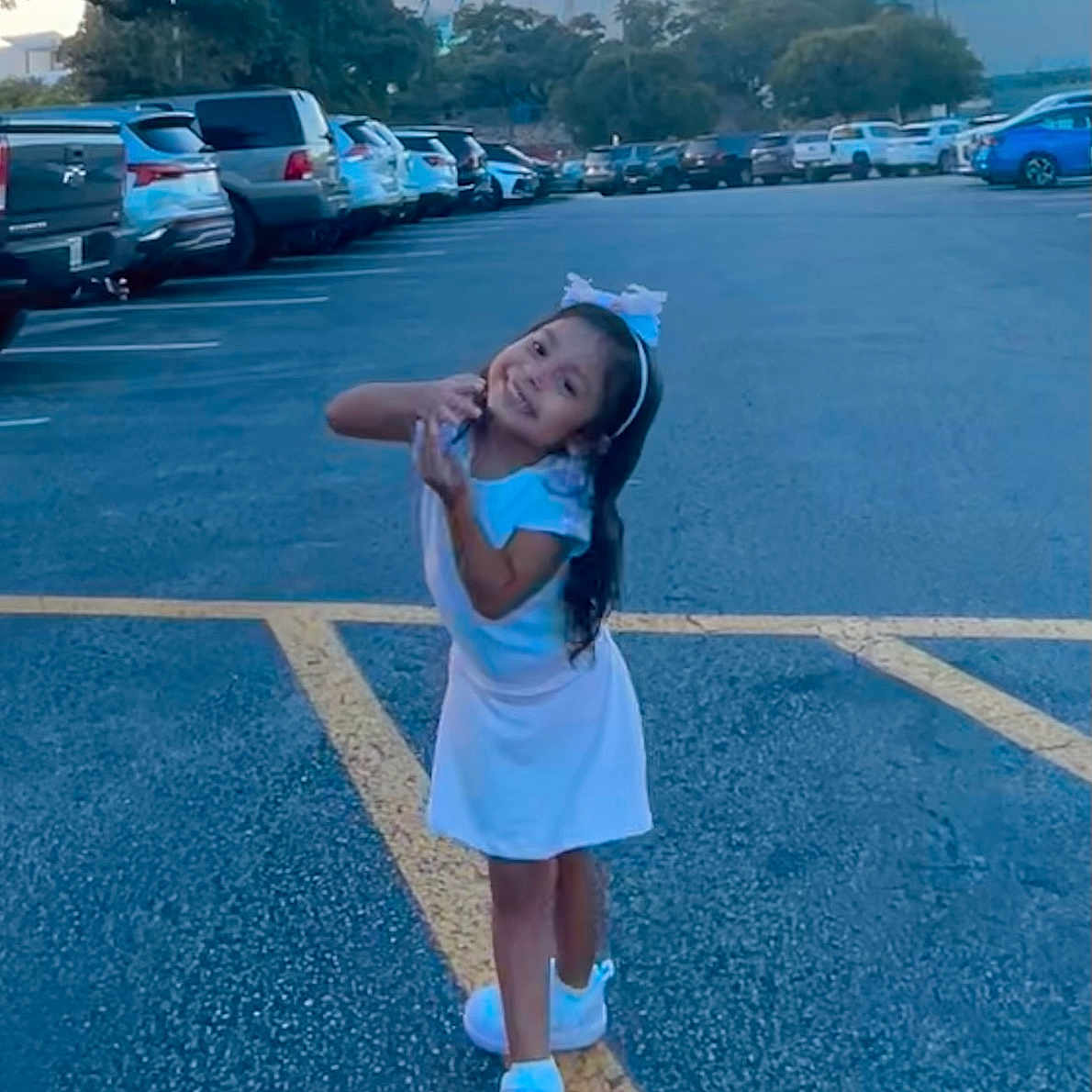 Xitlali joined the competition — help win amazing prizes! car, child, city, face, female, girl, happy, head, machine, outdoors, person, racket, smile, sport, tennis, tennisracket, transportation, urban, vehicle, wheel