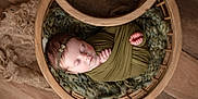 Adelaide joined the competition — help win amazing prizes! baby, basket, child, cozy, cute, green_cloth, headband, infant, knitted_blanket, newborn, peaceful, portrait, resting, sleep, sleeping, soft, top_view, wood_floor, wooden_basket, wrapped