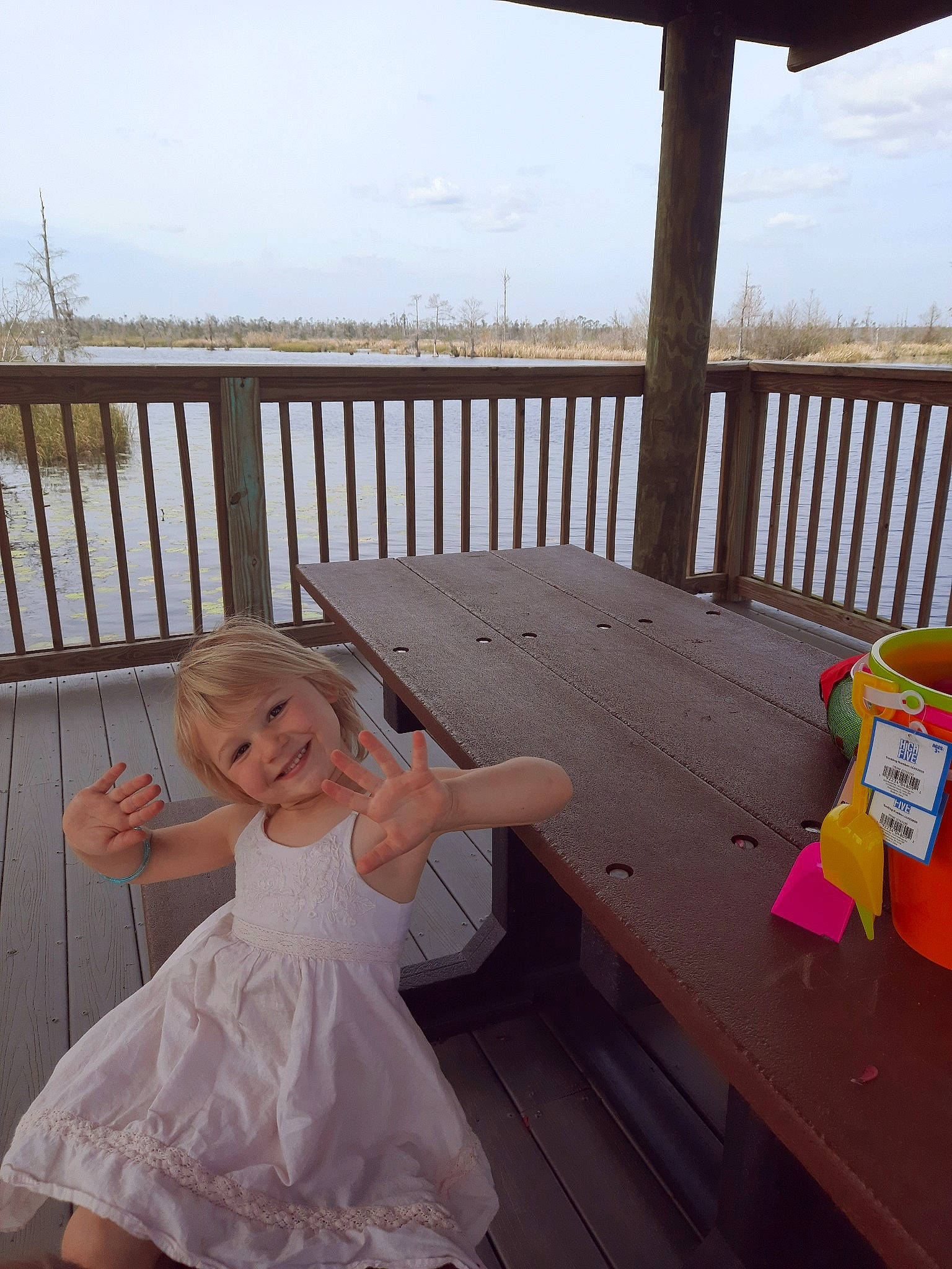 Norah joined the competition — help win amazing prizes! chair, dress, fence, flash_photography, formal_wear, fun, gown, happy, hardwood, joy, leisure, outdoor_furniture, outdoor_table, person, photograph, sky, smile, table, toddler, wedding_dress