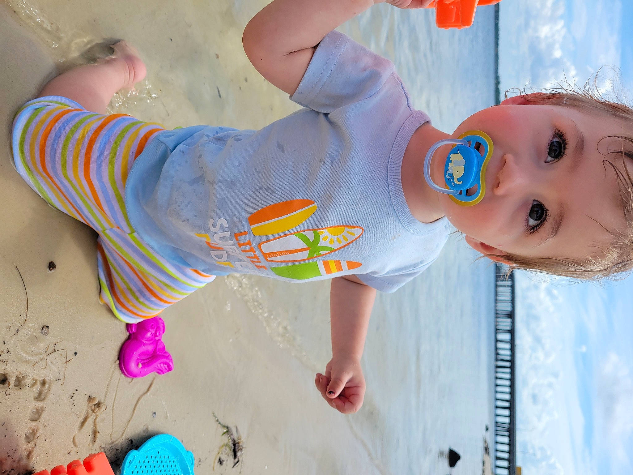 Cole joined the competition — help win amazing prizes! arm, beach, blue, child, cloud, fun, happy, human_leg, leisure, light, people_in_nature, people_on_beach, person, pink, red, sand, sky, standing, toddler, water