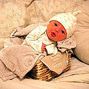 Richard is registered to the contest to win money with this photo: baby, blanket, basket, bed, pillow, hat, infant, cute, soft, cozy, face, person, sleepwear, fabric, indoors, rest, comfort, portrait, newborn, wrapped