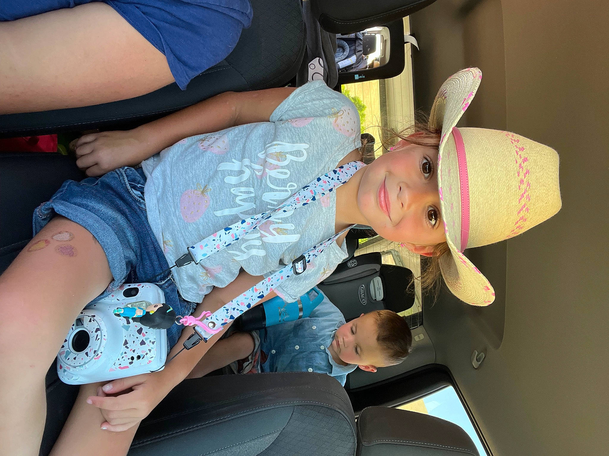 Kamdyn is registered to the contest to win money with this photo: auto_part, child, denim, elbow, electric_blue, event, finger, fun, hat, headwear, human_leg, joint, joy, knee, lap, nail, person, sitting, t_shirt, thigh