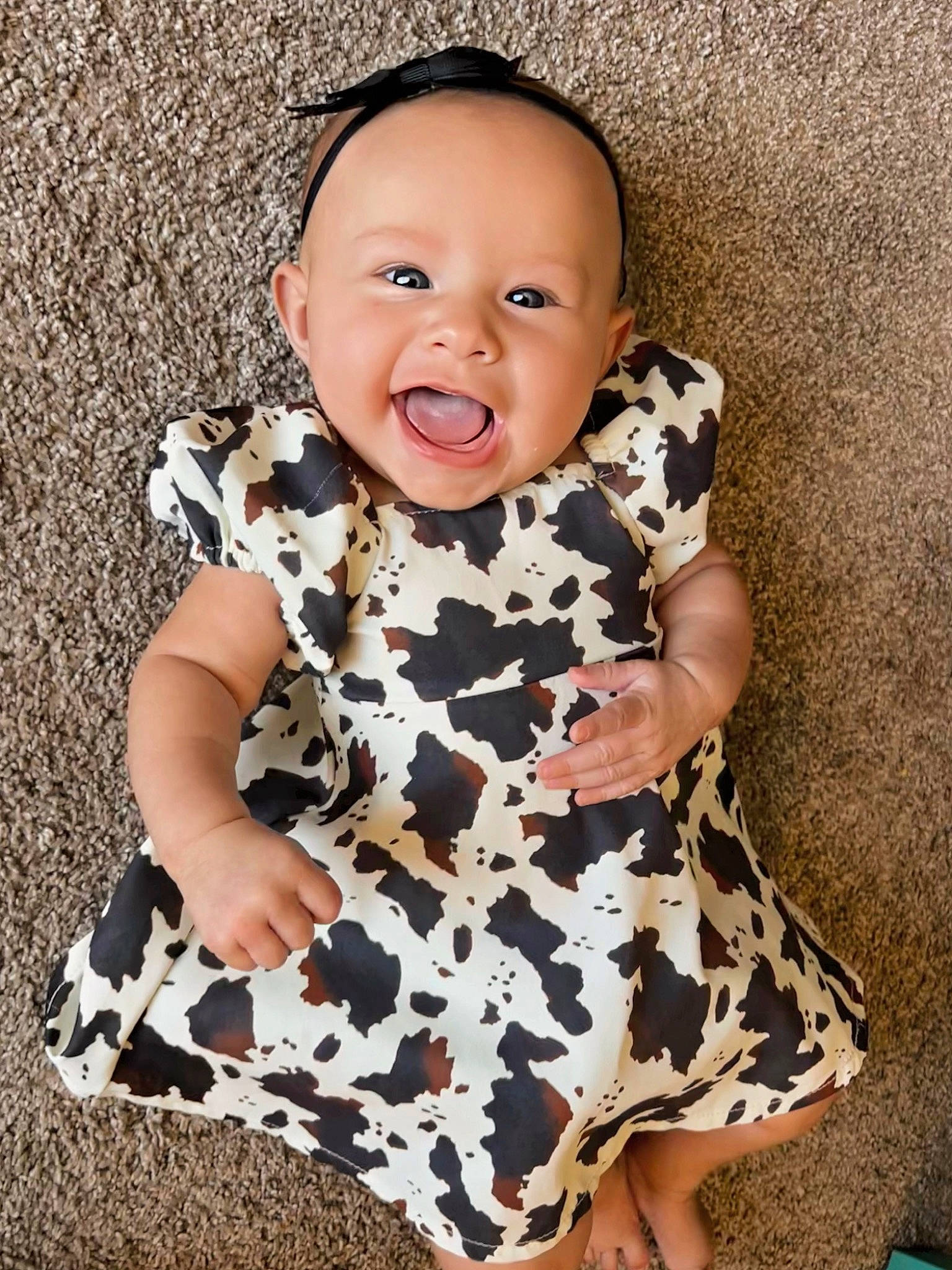 Blythe is registered to the contest to win money with this photo: baby, baby_toddler_clothing, child, collar, day_dress, dress, face, flash_photography, happy, head, neck, one_piece_garment, outerwear, pattern, person, skin, sleeve, smile, t_shirt, textile