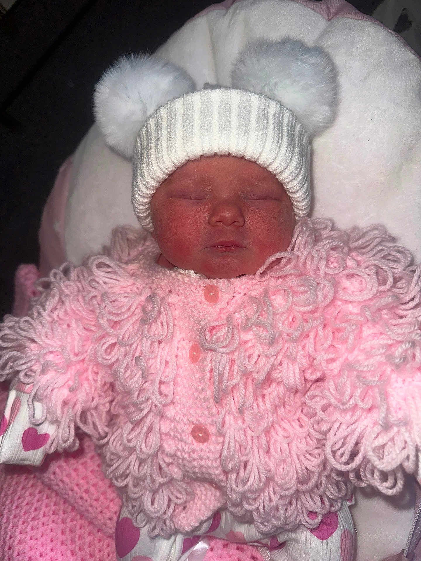 Vaughn joined the competition — help win amazing prizes! newborn, baby, sleeping, hat, pom_poms, pink, knitwear, sweater, cushion, heart_pattern, clothing, soft, infant, cute, cozy, indoors, child, portrait, warm, resting