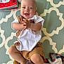 baby, smiling, clapping, playmat, blanket, toy, infant, happy, child, cute, indoor, patterned, clothing, feet, head, person, face, sitting, young, toddler