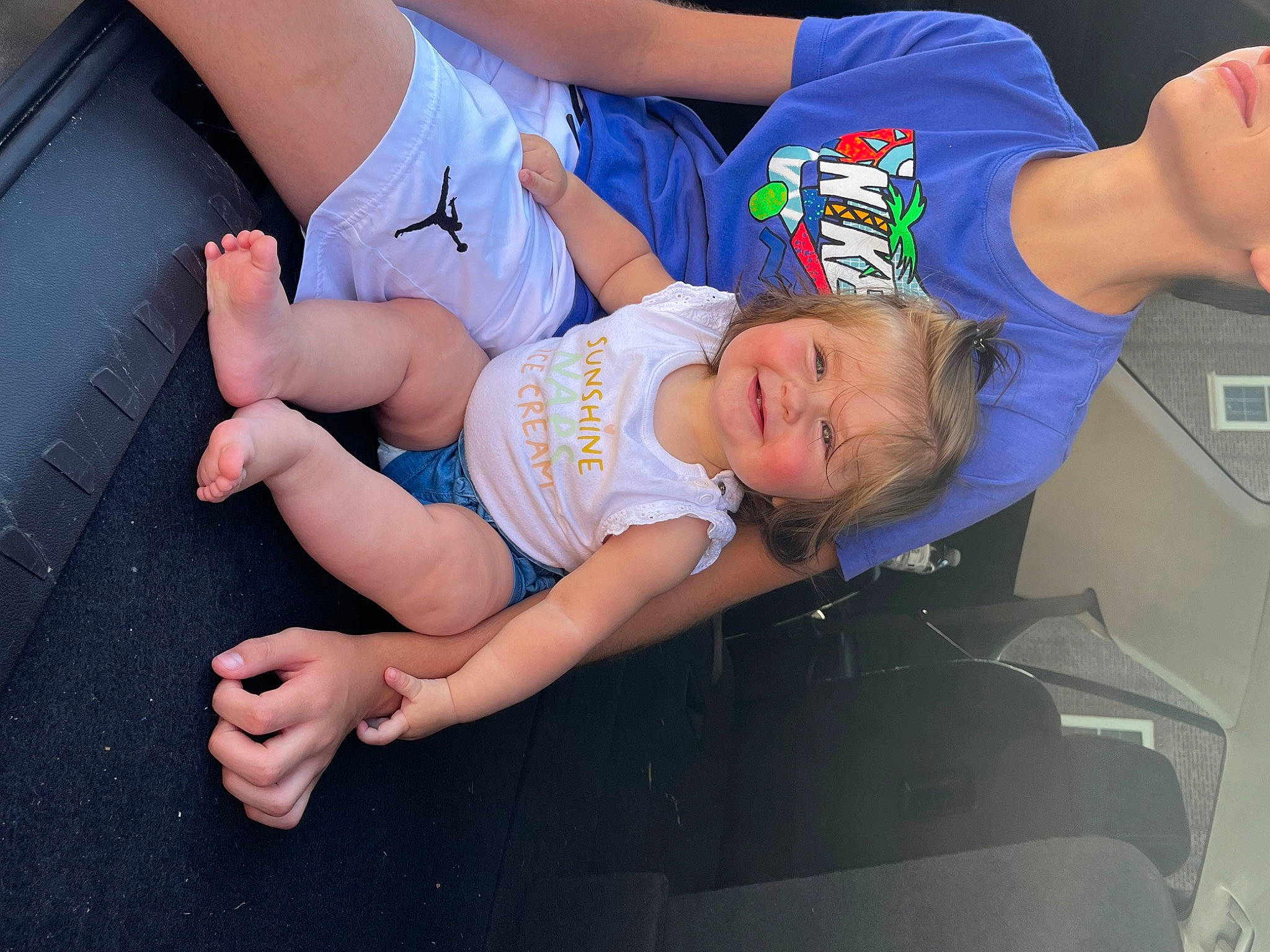 Francesca is registered to the contest to win money with this photo: abdomen, baby, baby_toddler_clothing, elbow, electric_blue, finger, foot, fun, gesture, happy, human_leg, joy, knee, lap, leisure, person, shorts, t_shirt, thigh, toddler
