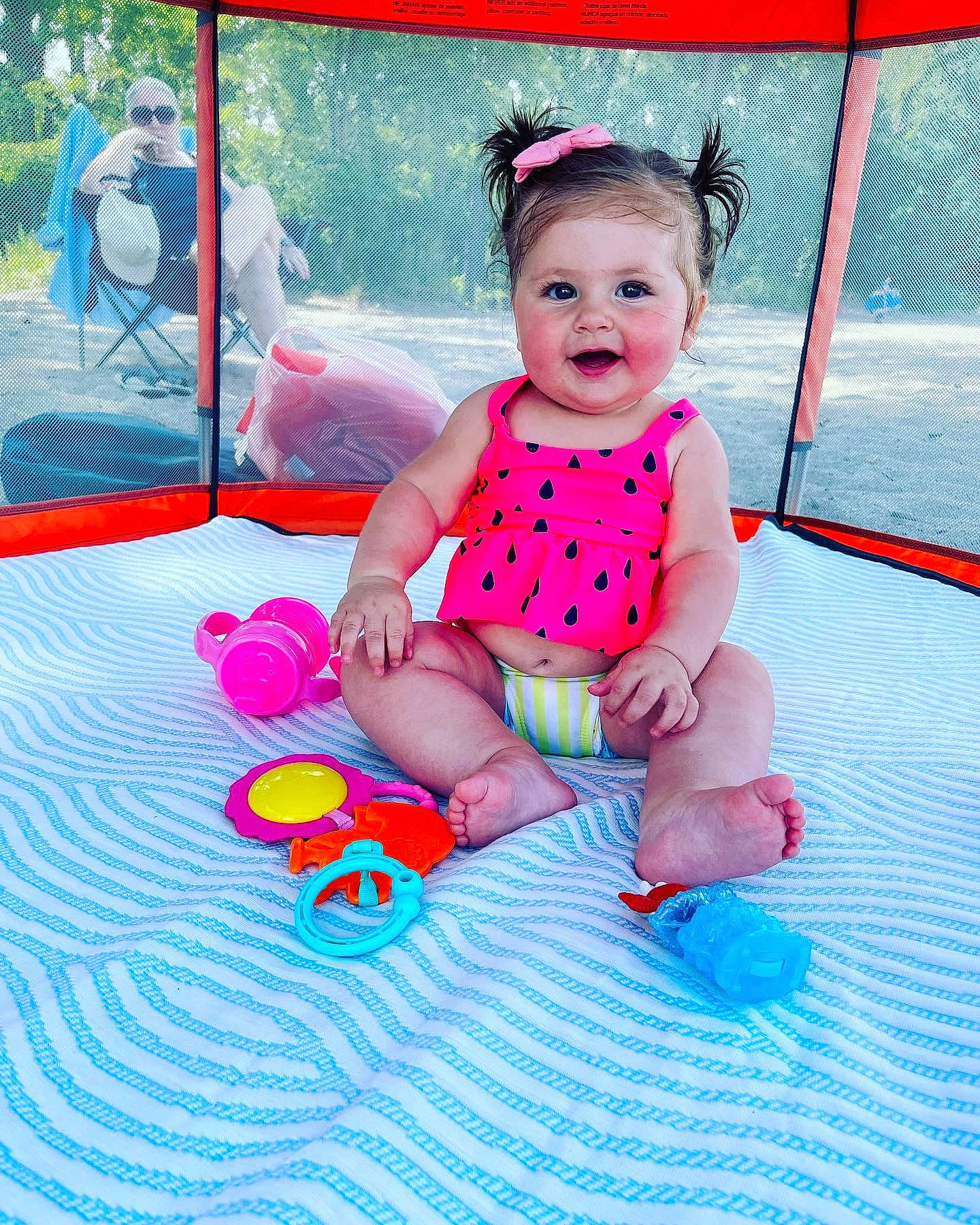 Francesca is registered to the contest to win money with this photo: baby, baby_products, baby_toddler_clothing, child, fun, grass, happy, joy, leisure, magenta, outdoor_play_equipment, pattern, person, pink, play, public_space, recreation, sitting, smile, toddler