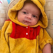 Timéo a rejoint le concours — aidez-le/la à gagner de superbes lots ! baby, child, comfort, cute, ears, expression, eyes, face, fuzzy_clothing, hood, indoor, infant, onesie, pattern, person, portrait, red, seat, sitting, yellow