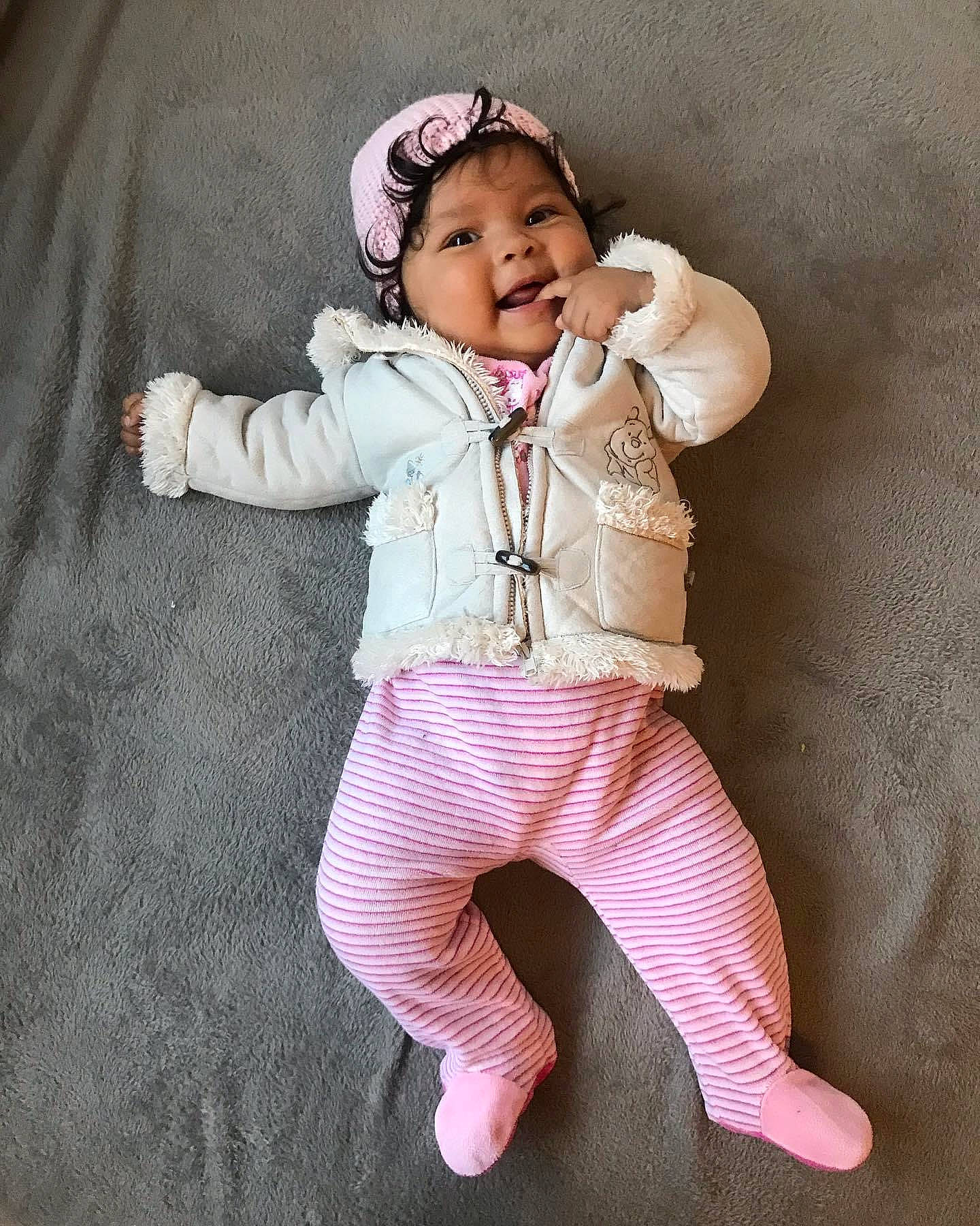 Victoria participe au concours pour gagner de l'argent avec cette photo : baby, baby_toddler_clothing, child, collar, dress_shirt, eye, face, gesture, happy, head, headwear, human_body, outerwear, pattern, person, pink, skin, sleeve, smile, textile