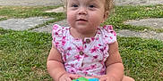 Laelynn is registered to the contest to win money with this photo: toddler, child, grass, ball, outdoor, bow, pink_dress, toy, summer, greenery, house, sidewalk, curly_hair, cute, sitting, playful, daylight, happy, nature, portrait