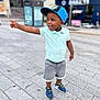 child, toddler, boy, cap, blue_cap, polo_shirt, mint_shirt, shorts, gray_shorts, sneakers, blue_sneakers, sidewalk, street, urban, pointing, happy, smiling, outdoor, daylight, person