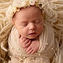 Sawyer is registered to the contest to win money with this photo: newborn, baby, sleeping, wrapped, cream_color, floral_headband, pearls, soft_texture, cozy, closeup, infant, cute, peaceful, portrait, hands, face, delicate, soft_lighting, blanket, adorable
