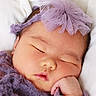 baby, sleeping, newborn, purple_headband, purple_outfit, soft_blanket, closeup, peaceful, cute, infant, portrait, resting, child, face, hand, delicate, tulle, soft_texture, cozy, adorable