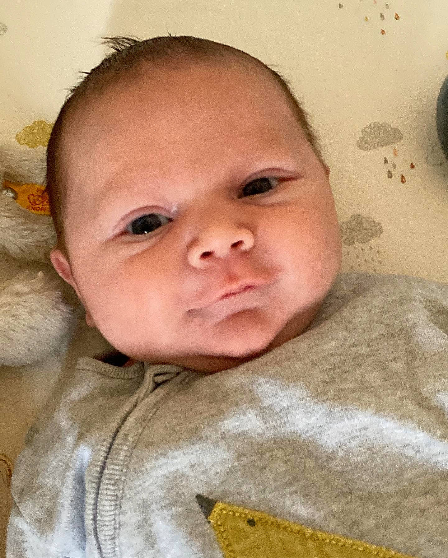 Henry is registered to the contest to win money with this photo: baby, baby_toddler_clothing, cheek, child, chin, close_up, comfort, eyebrow, eyelash, face, happy, iris, linens, lip, neck, nose, person, skin, sleeve, smile