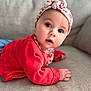 Lou participe au concours pour gagner de l'argent avec cette photo : baby, infant, headband, bow, red_sweater, couch, sofa, portrait, big_eyes, gaze, cute, lying_down, hand, skin, indoor, close_up, soft_light, fabric, knitwear, expression