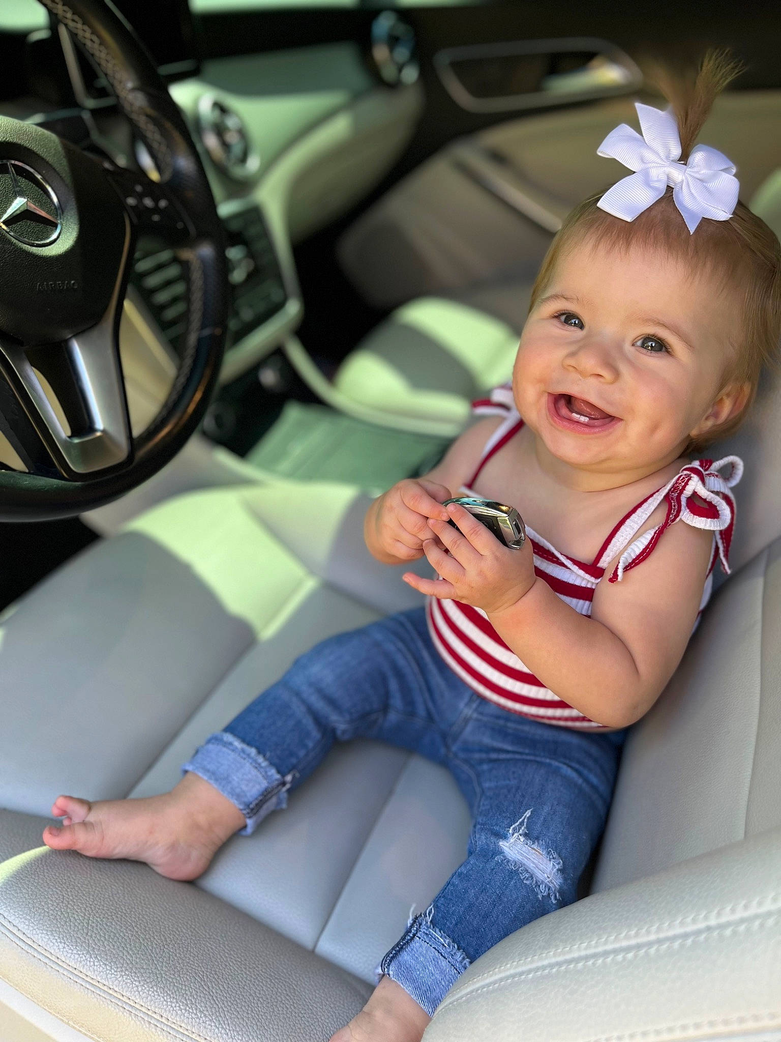 Taylyn is registered to the contest to win money with this photo: auto_part, automotive_design, automotive_wheel_system, baby_toddler_clothing, car, car_seat, car_seat_cover, happy, human_leg, joy, knee, leg, motor_vehicle, person, personal_luxury_car, smile, steering_part, steering_wheel, thigh, toddler
