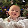 baby, smile, blanket, christmas_tree, ornaments, holiday, festive, happy, infant, cozy, cute, indoors, decorations, seasonal, child, portrait, warm, soft, celebration, tree