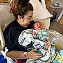 newborn, baby, mother, hospital, bed, blanket, pacifier, person, woman, holding, clothing, medical_equipment, room, pillow, face, hair, hand, furniture, indoor, caring