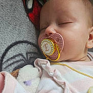 Elizabeth joined the competition — help win amazing prizes! baby, sleeping, pacifier, blanket, spiderman, face, infant, child, cute, pink_clothing, soft_texture, closeup, peaceful, resting, chain, head, skin, indoors, cozy, portrait